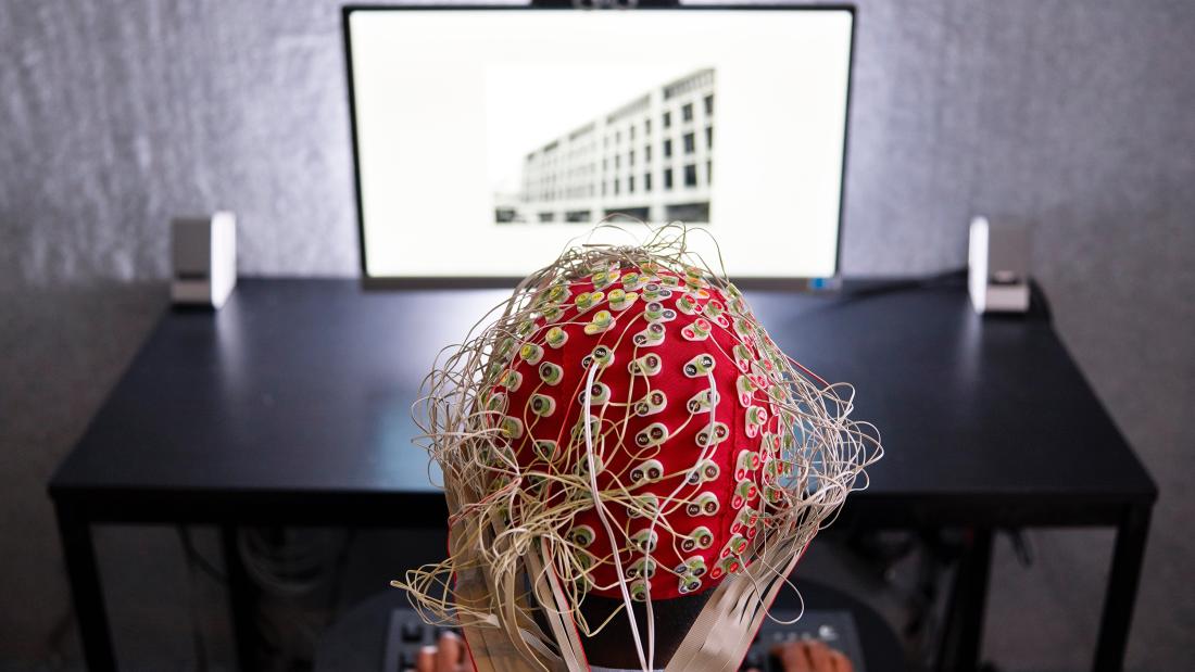 Students wearing headpiece in Psychology experiment